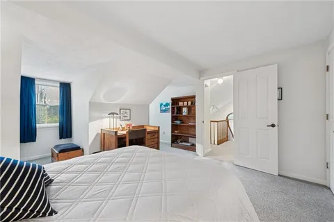 a bedroom with furniture and window