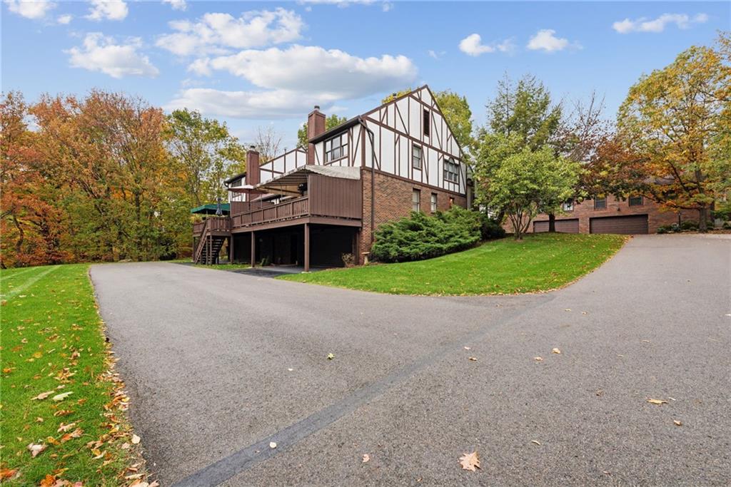 601 Timber Lane Sewickley, PA 15143 - Photo 37 of 45 a front view of a house with a yard and garage