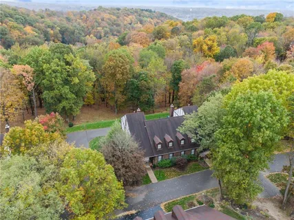 an aerial view of a house with a yard