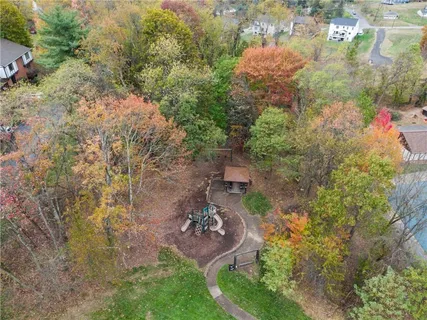 an aerial view of a house with a yard and lake view