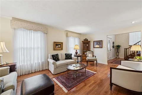 a living room with furniture potted plant and a window