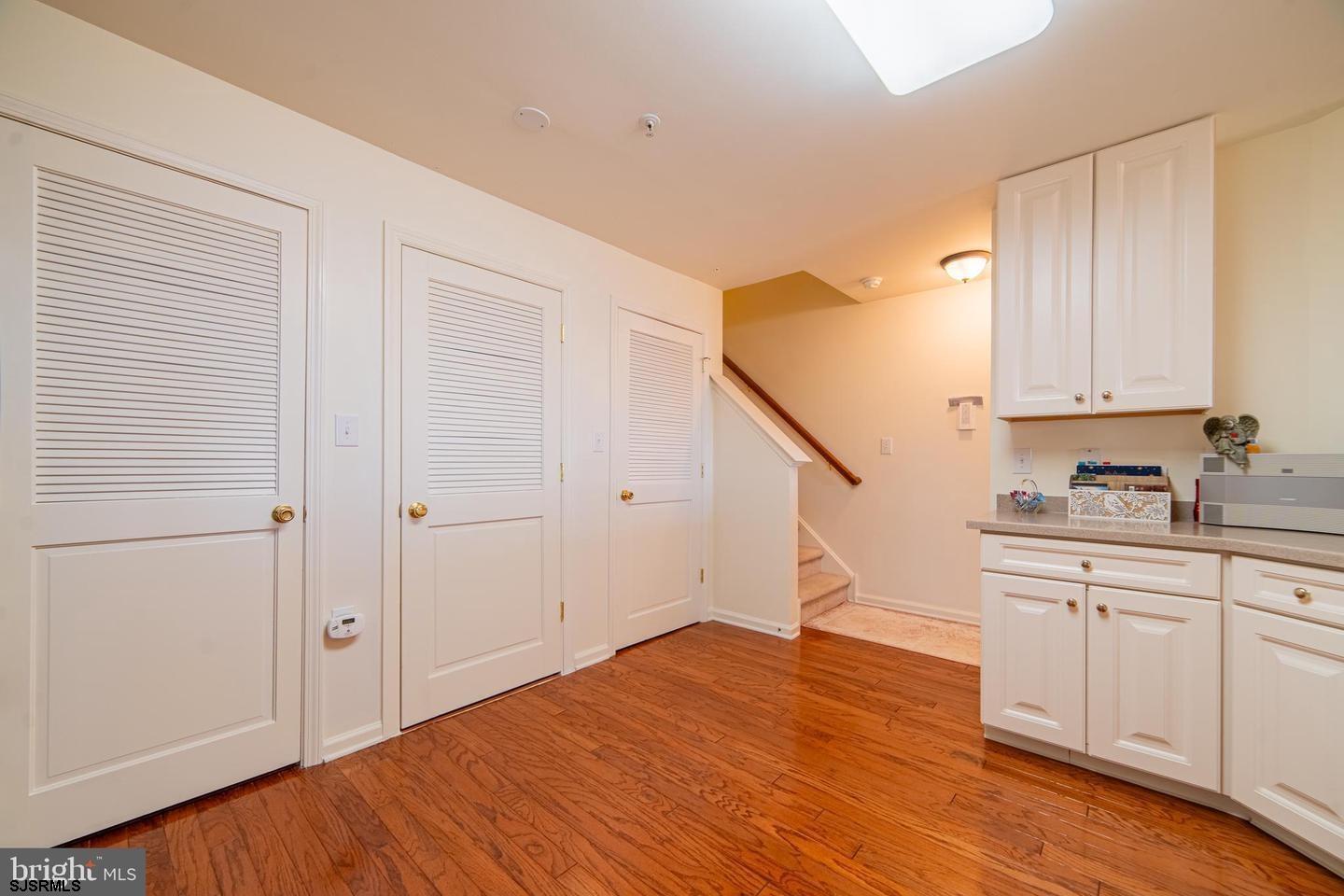 61 Dockside Drive, Unit 61 Somers Point, NJ 08244 - Photo 14 of 20 a view of a kitchen with wooden floor and electronic appliances