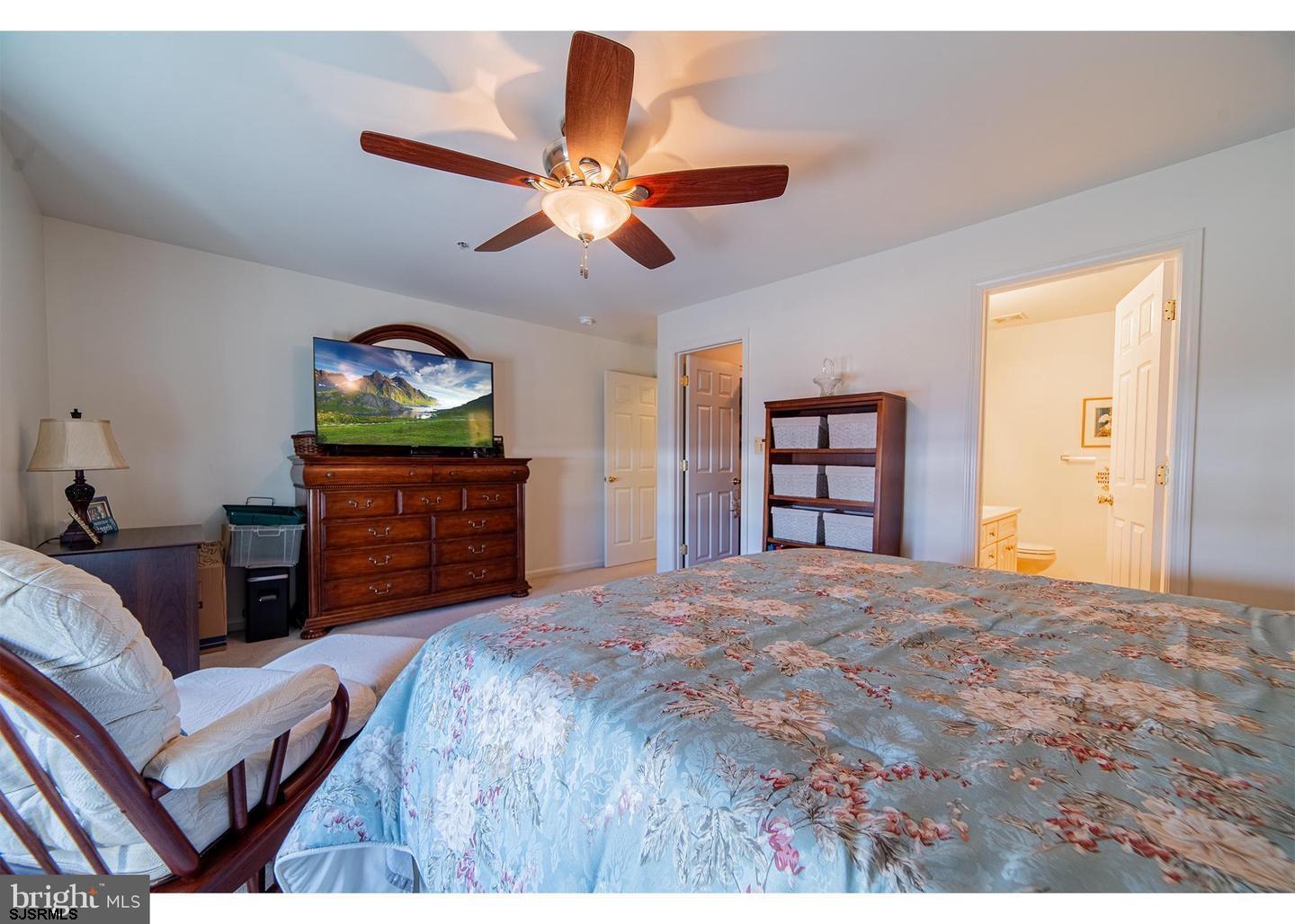 61 Dockside Drive, Unit 61 Somers Point, NJ 08244 - Photo 18 of 20 a bedroom with a bed and a ceiling fan