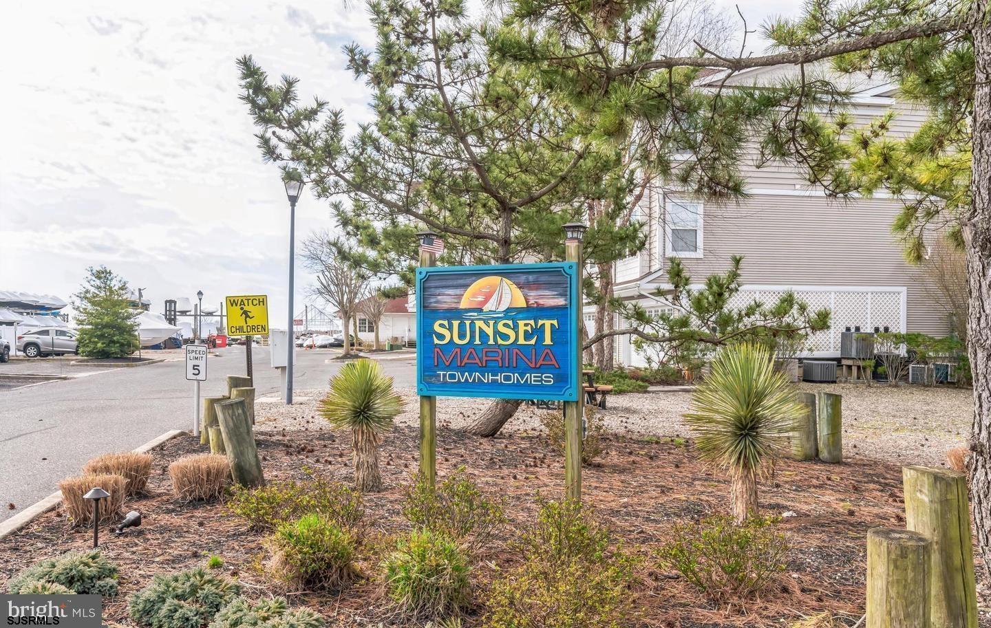 61 Dockside Drive, Unit 61 Somers Point, NJ 08244 - Photo 5 of 20 a sign board with buildings in the background