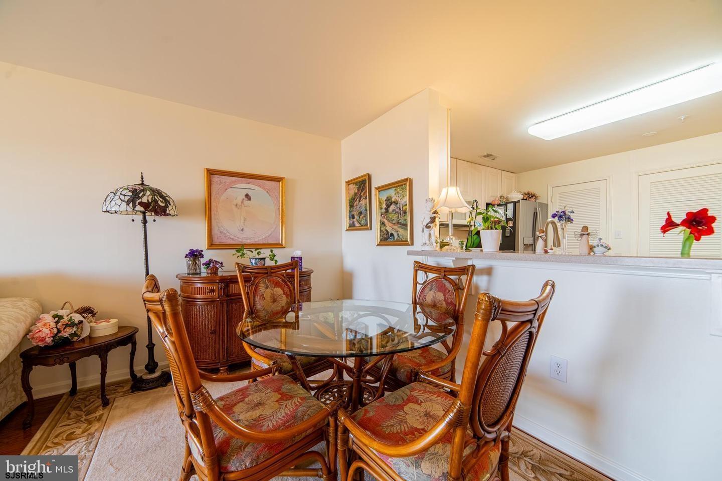 61 Dockside Drive, Unit 61 Somers Point, NJ 08244 - Photo 8 of 20 a view of a dining room with furniture and wooden floor