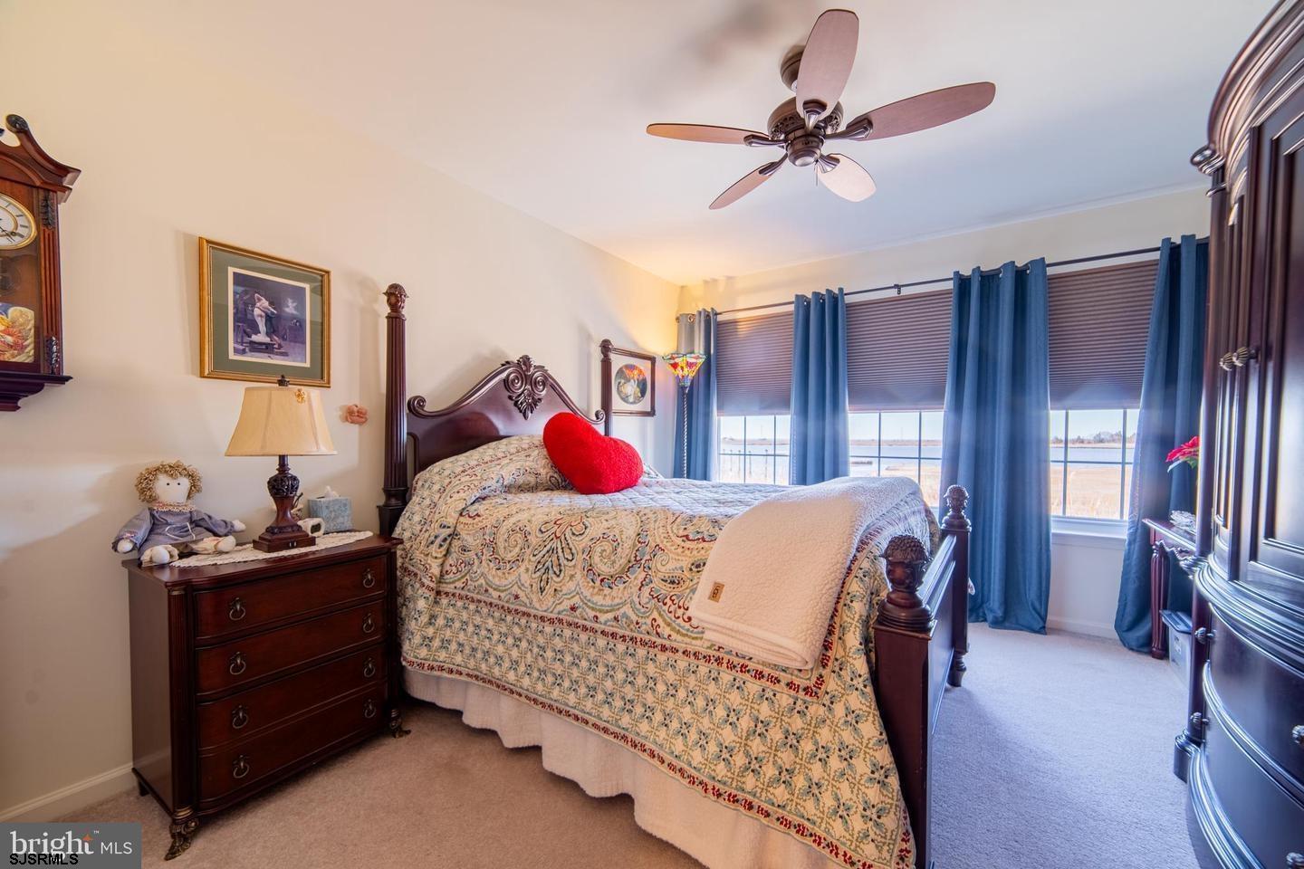 61 Dockside Drive, Unit 61 Somers Point, NJ 08244 - Photo 10 of 20 a bedroom with a bed dresser and a window