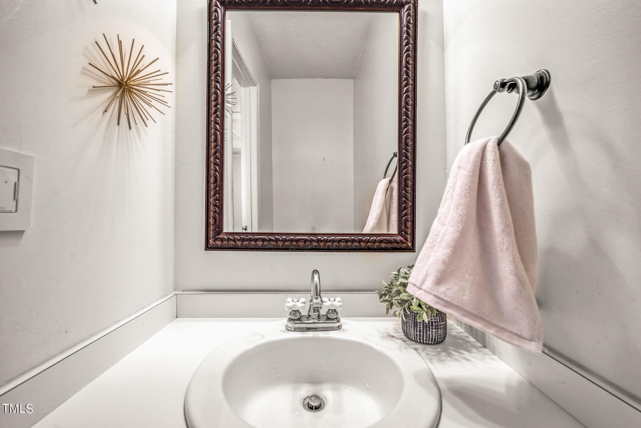 4117 Cary Oaks Drive Apex, NC 27539 - Photo 17 of 38 a bathroom with a sink and a mirror