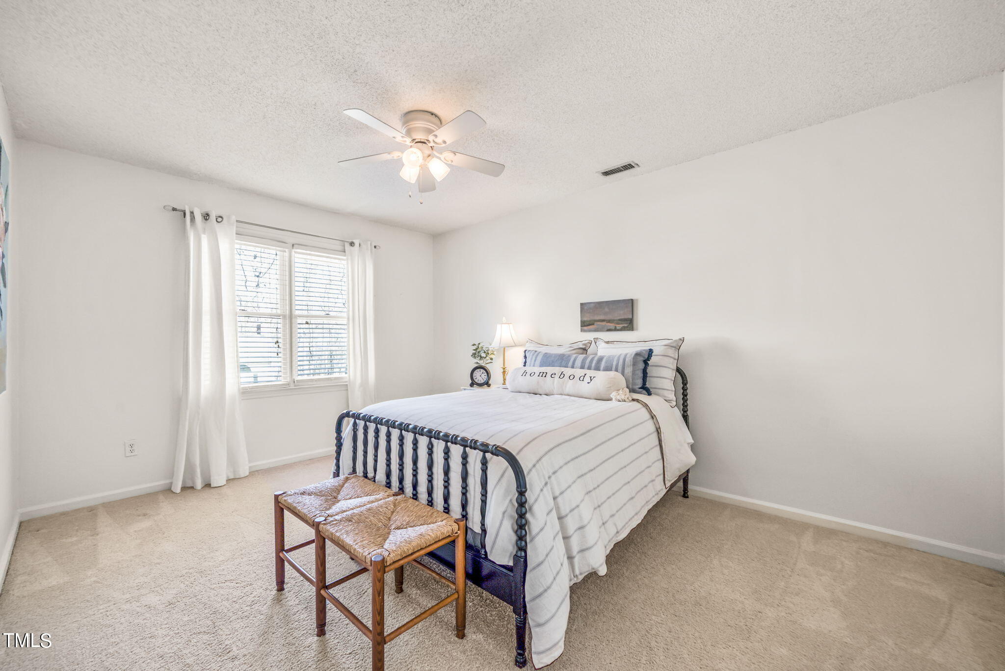 4117 Cary Oaks Drive Apex, NC 27539 - Photo 18 of 38 a bedroom with a bed and a window