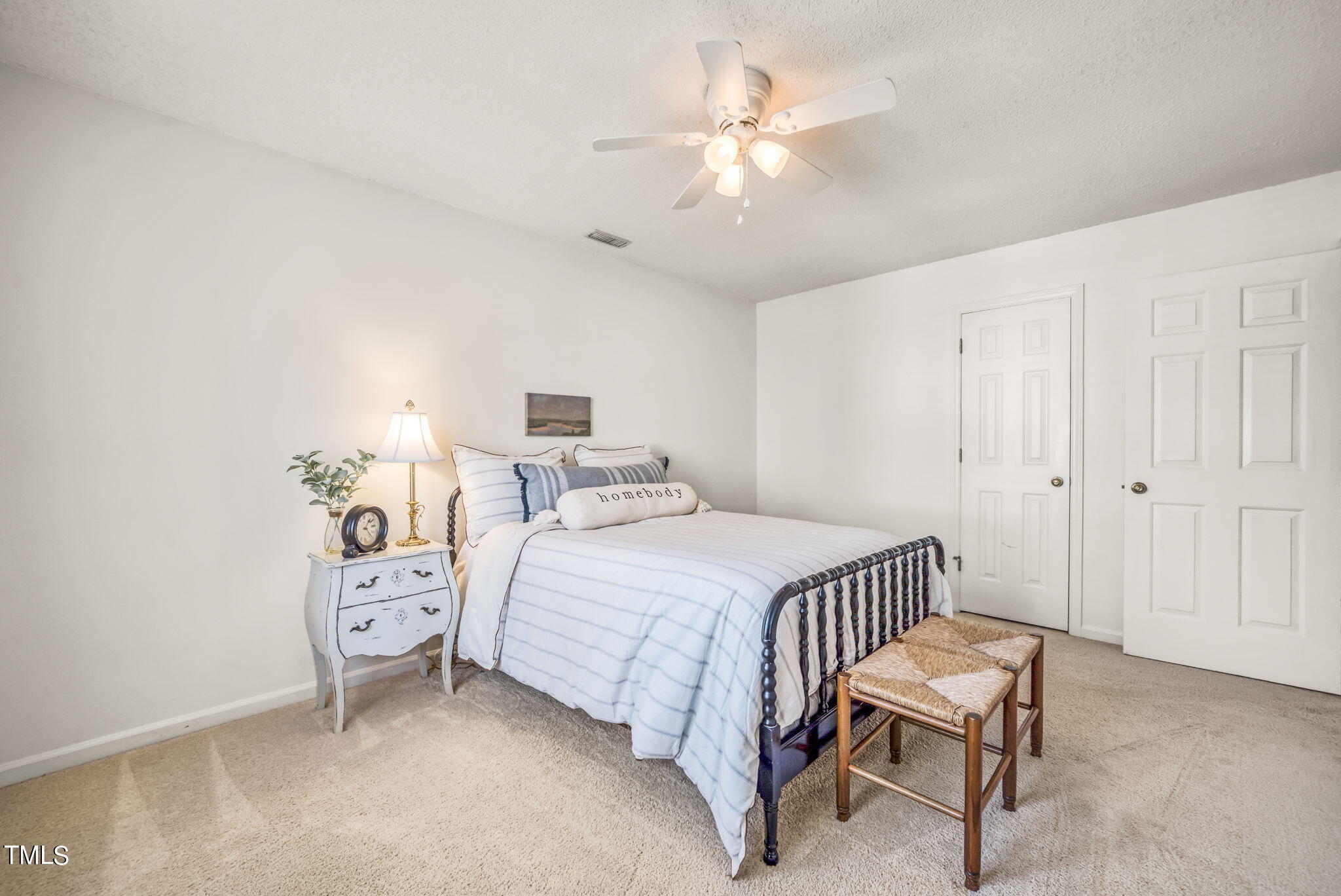 4117 Cary Oaks Drive Apex, NC 27539 - Photo 19 of 38 a bedroom with a bed and a chandelier