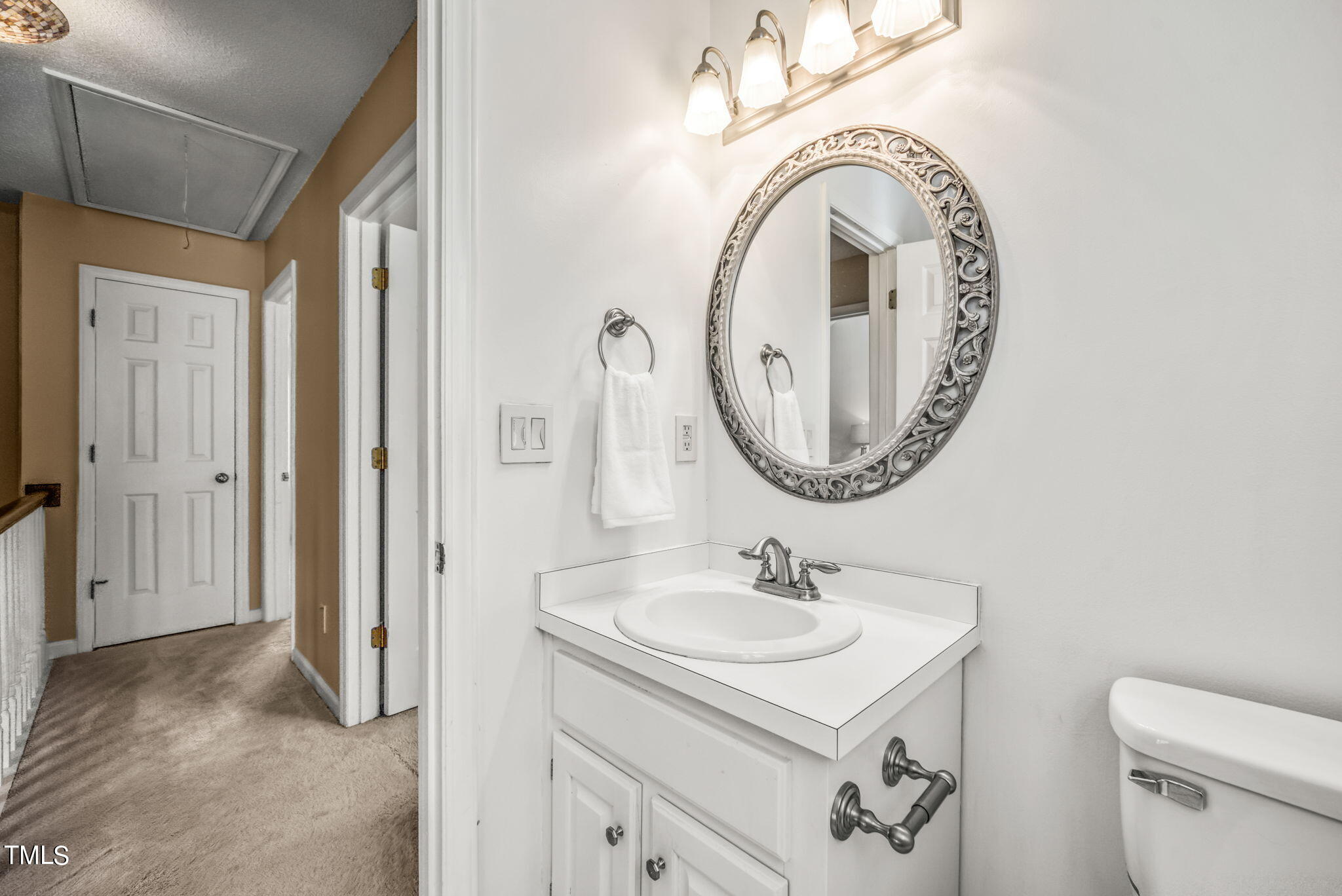 4117 Cary Oaks Drive Apex, NC 27539 - Photo 20 of 38 a bathroom with a sink and a mirror
