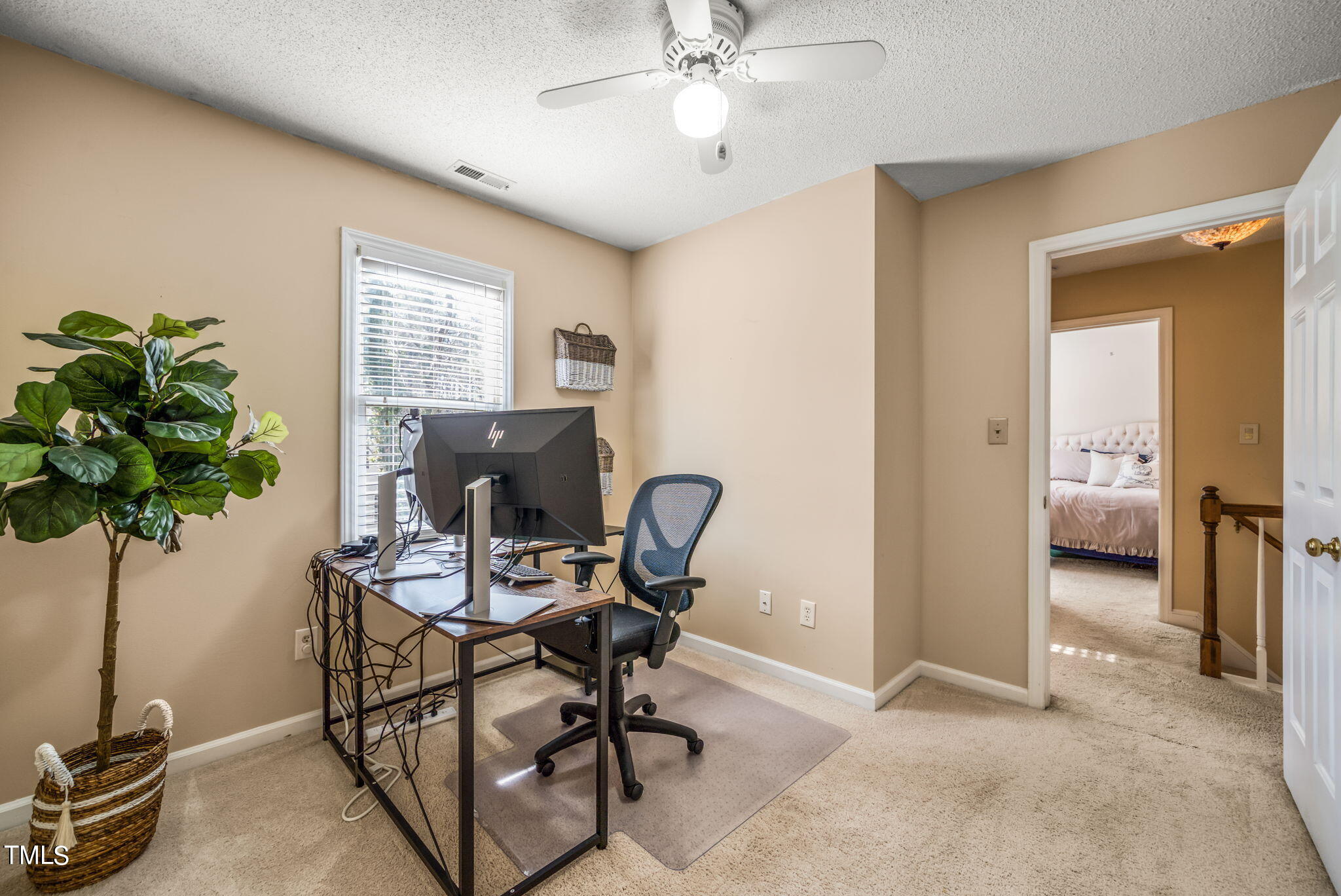 4117 Cary Oaks Drive Apex, NC 27539 - Photo 5 of 38 a workspace with furniture and a potted plant