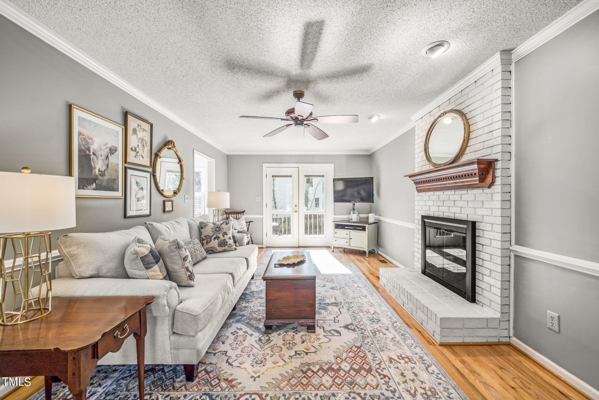 4117 Cary Oaks Drive Apex, NC 27539 - Photo 9 of 38 a living room with furniture a fireplace and a chandelier