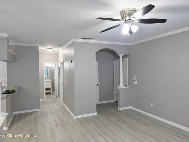a view of a hallway with wooden floor