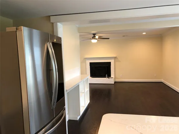 a view of kitchen with stainless steel appliances wooden floor