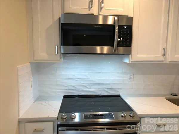 a stove top oven sitting inside of a kitchen