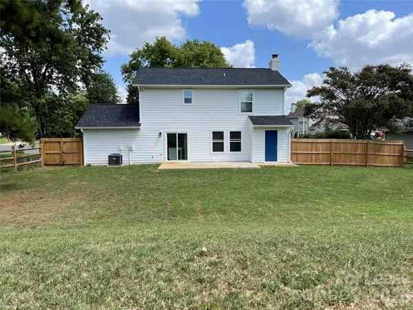 a front view of house with yard and trees