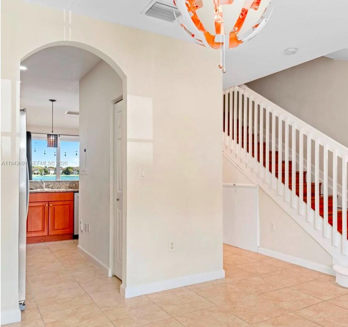 9155 Southwest 227th Street, Unit 5 Cutler Bay, FL 33190 - Photo 6 of 8 a view of hallway with cabinets and wooden floor