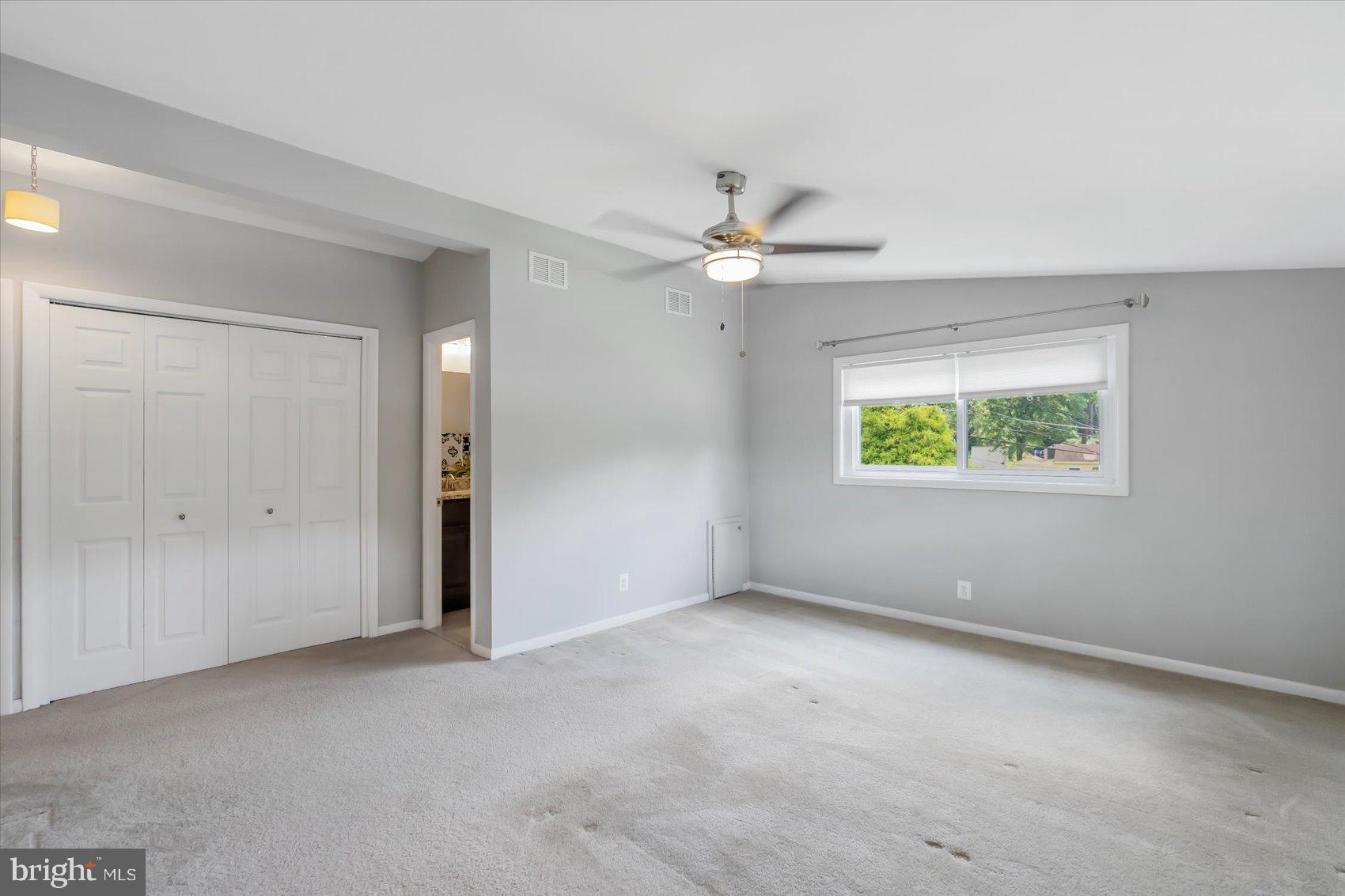 5818 Stuart Avenue Baltimore, MD 21215 - Photo 26 of 64 Primary bedroom w/ ceiling fan and privacy windows