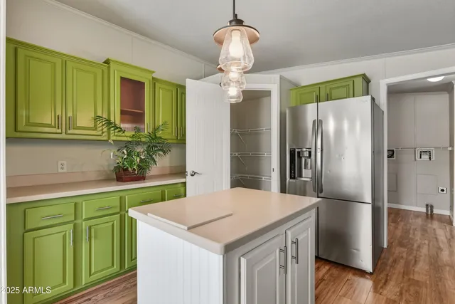 a kitchen with cabinets a center island and stainless steel appliances