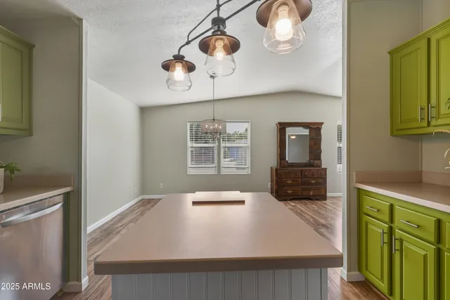 a kitchen with cabinets and wooden floor