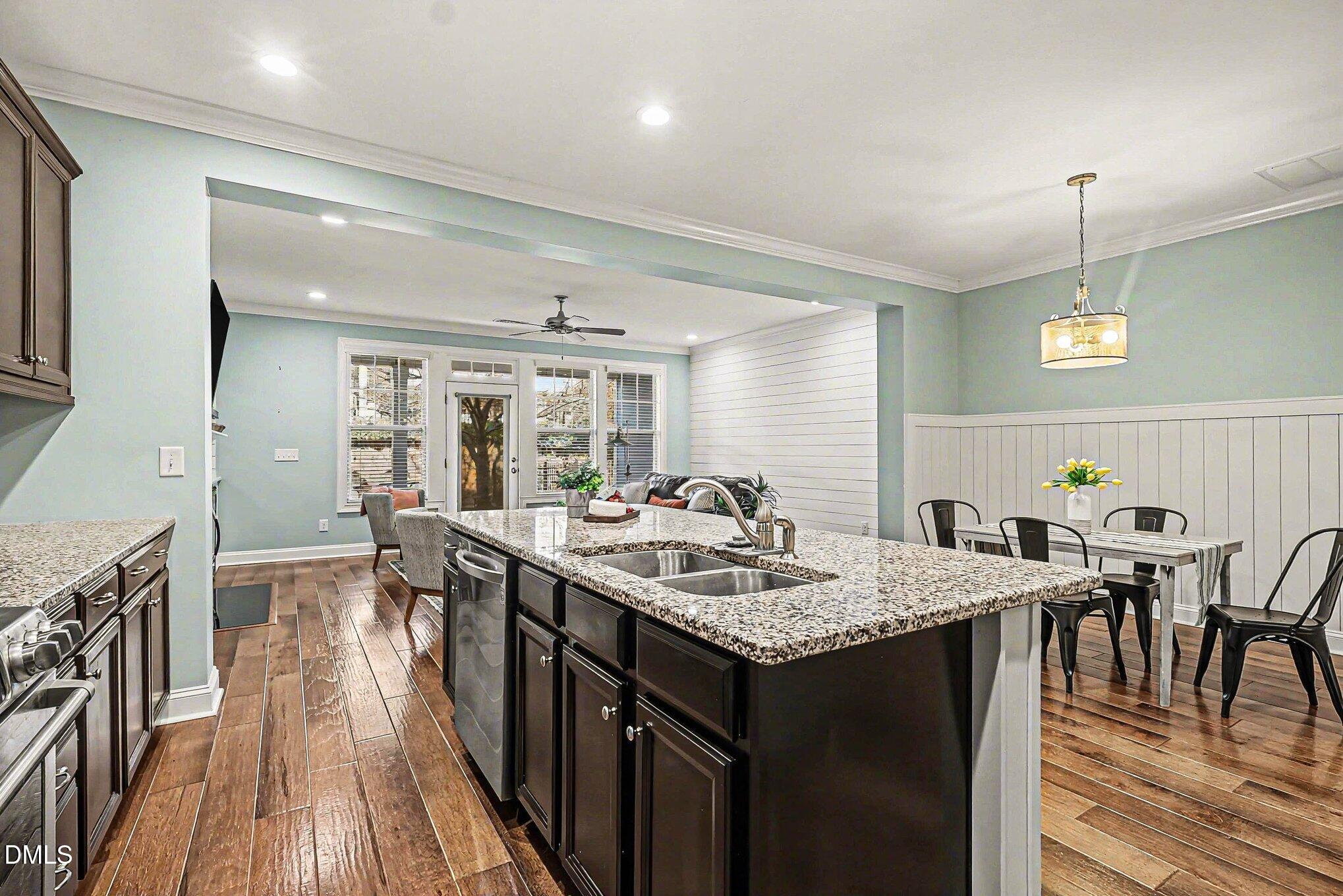 653 Fallon Grove Way Raleigh, NC 27608 - Photo 8 of 38 a kitchen with counter space sink stove and wooden floor