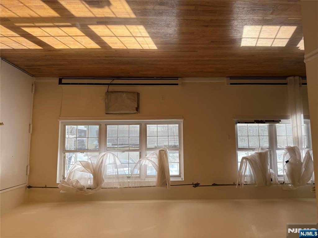 419 Paterson Avenue East Rutherford, NJ 07073 - Photo 4 of 5 a view of an empty room with wooden floor and a window