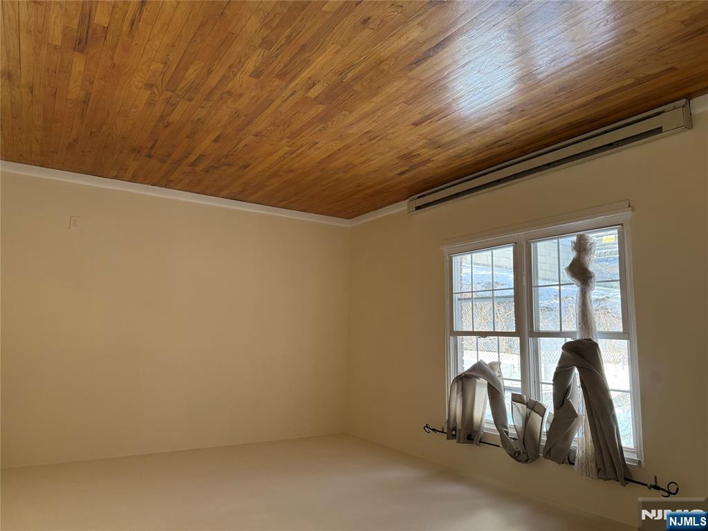 419 Paterson Avenue East Rutherford, NJ 07073 - Photo 5 of 5 a view of an empty room with wooden floor and a window