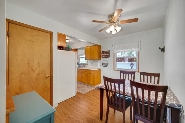 a dining room with furniture and a window
