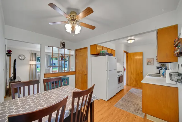 a view of a dining room with furniture and a chandelier