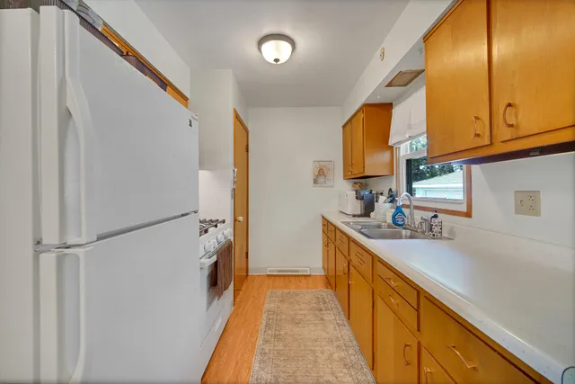 a kitchen with stainless steel appliances granite countertop a refrigerator and a sink
