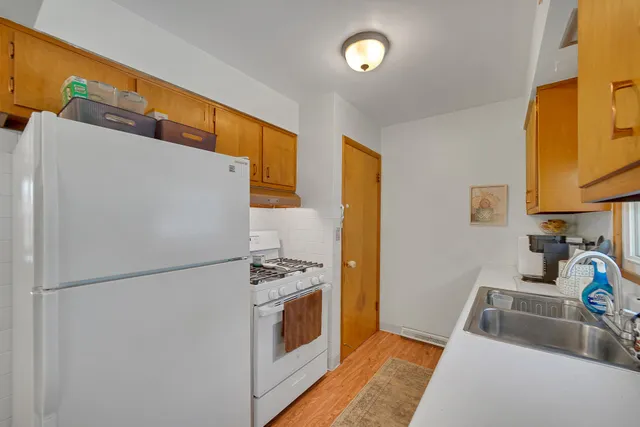 a kitchen with stainless steel appliances a refrigerator sink and stove