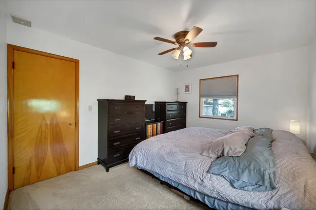 a bedroom with a bed and a dresser