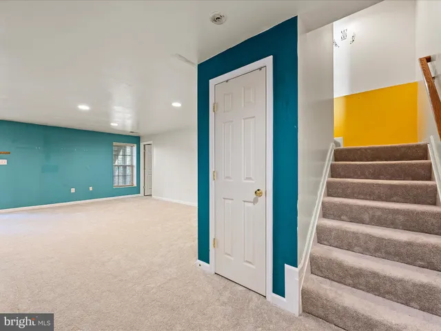 a view of an empty room with a kitchen