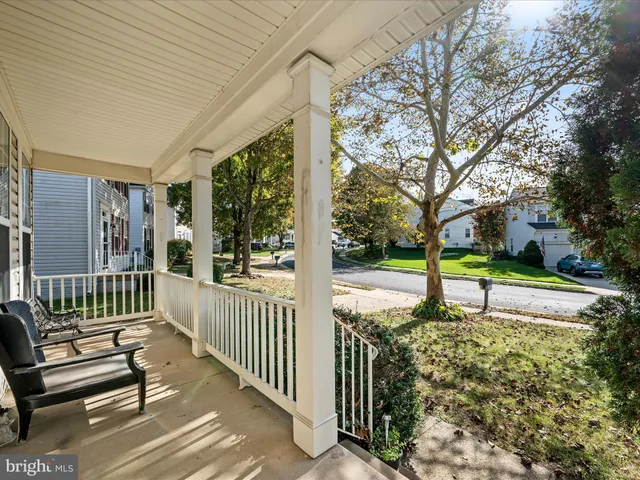 a view of a house with a small yard and wooden fence