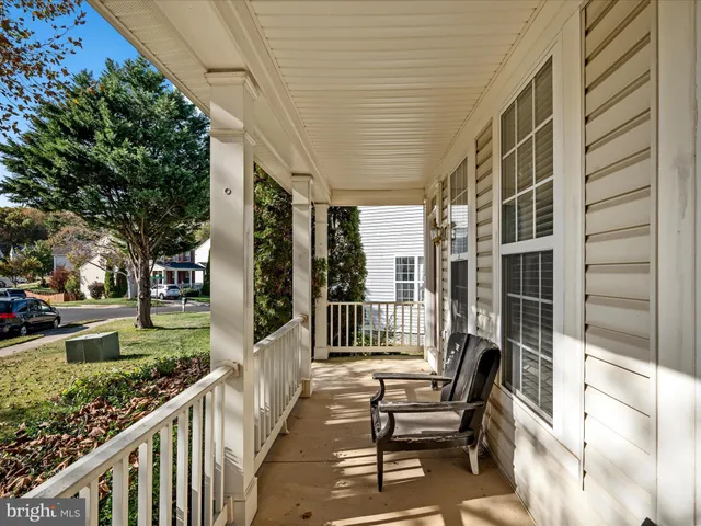 a view of a porch with furniture and garden