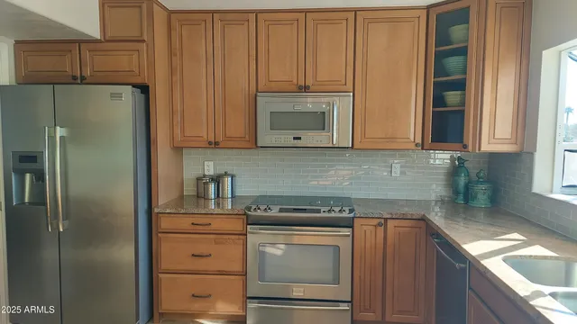 a kitchen with appliances cabinets and a window