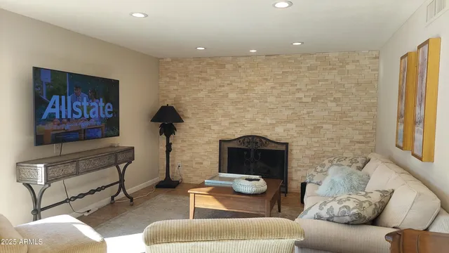 a living room with furniture and a fireplace