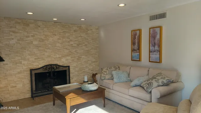 a living room with furniture and a fireplace
