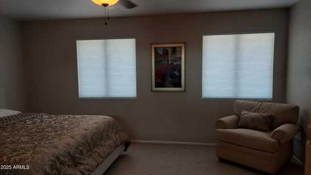 a bedroom with a bed couch and window