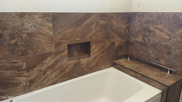 a bathroom with a granite countertop sink and vanity