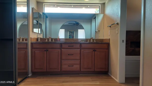 a bathroom with a granite countertop sink a mirror and a vanity