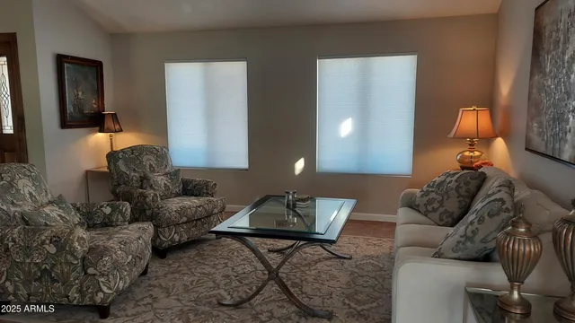 a living room with furniture and a lamp