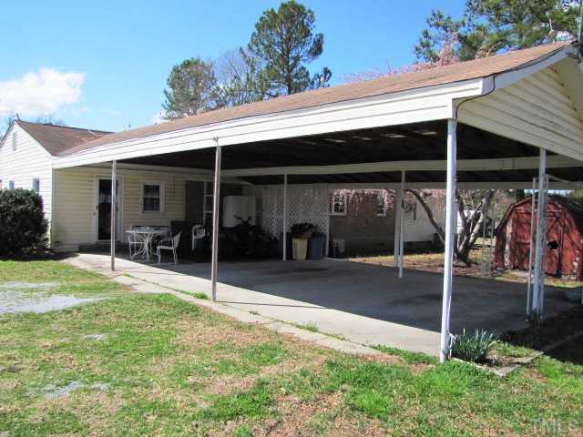 1308 Bacon Road Timberlake, NC 27583 - Photo 8 of 12 a view of a patio with table and chairs under an umbrella