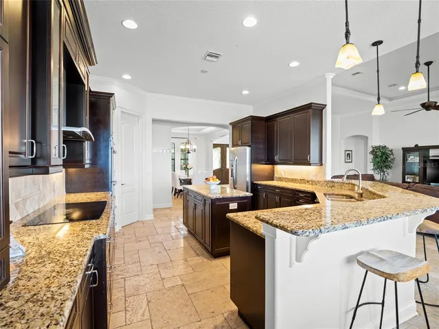 a kitchen with granite countertop a sink and a stove