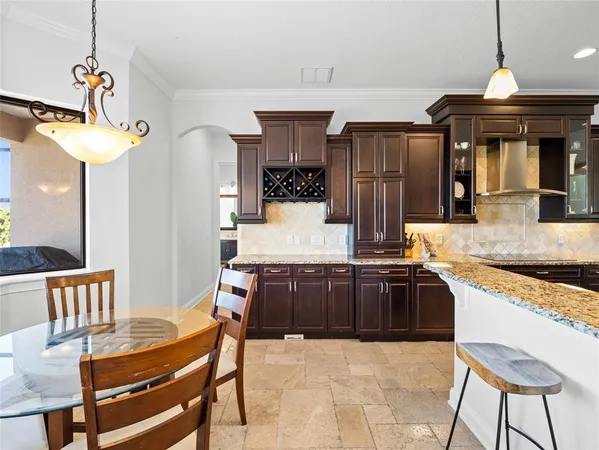 a kitchen with stainless steel appliances granite countertop a stove a sink dishwasher and a refrigerator with wooden floor