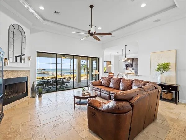 a living room with furniture a fireplace and a chandelier