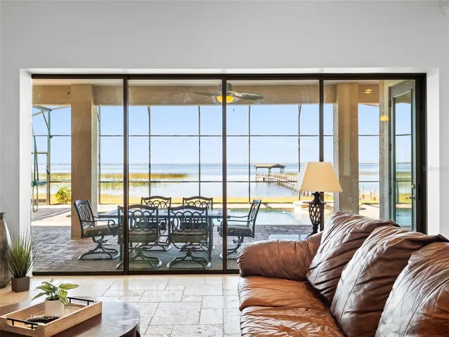 a view of a bedroom with furniture and floor to ceiling window