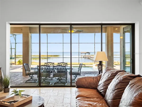 a view of a bedroom with furniture and floor to ceiling window