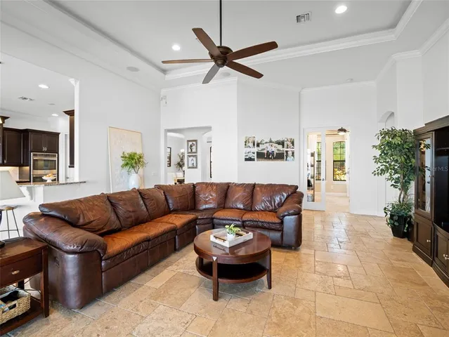 a living room with furniture and a ceiling fan