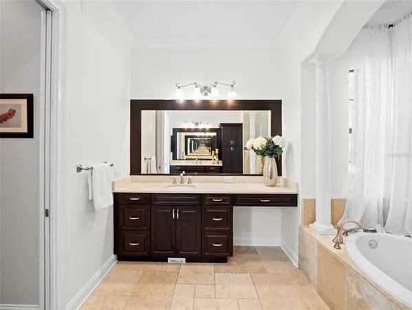 a spacious bathroom with a granite countertop sink and a mirror